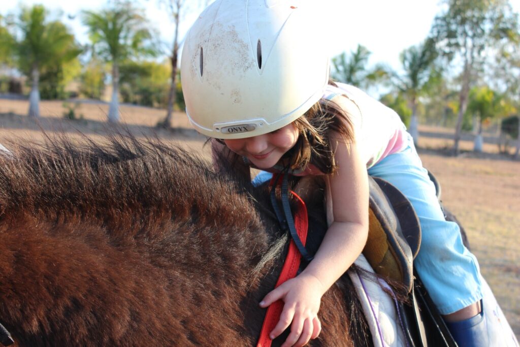 Small girl riding a horse